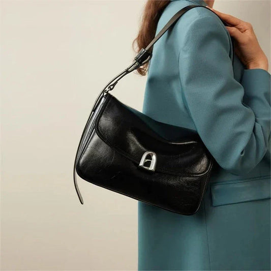 Elegant square-shaped burgundy leather shoulder and crossbody bag for women, featuring a modern design and spacious interior.