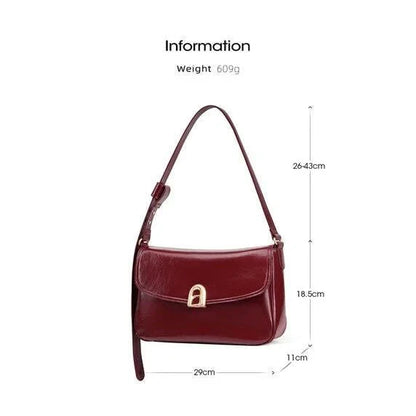 Elegant square-shaped burgundy leather shoulder and crossbody bag for women, featuring a modern design and spacious interior.