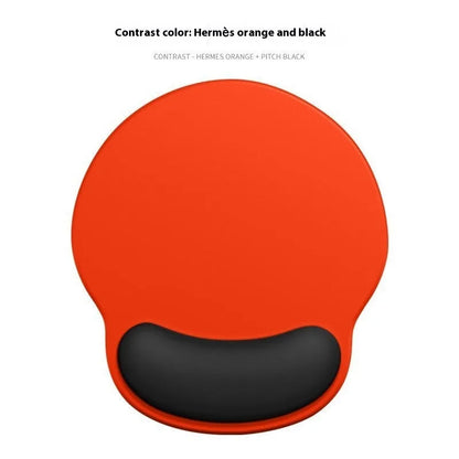 Silicone mouse mat with integrated wrist rest in a gradient blue black colour on a desk.