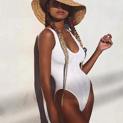 Women's solid colour seersucker one-piece swimsuit in a backless, sleeveless design.