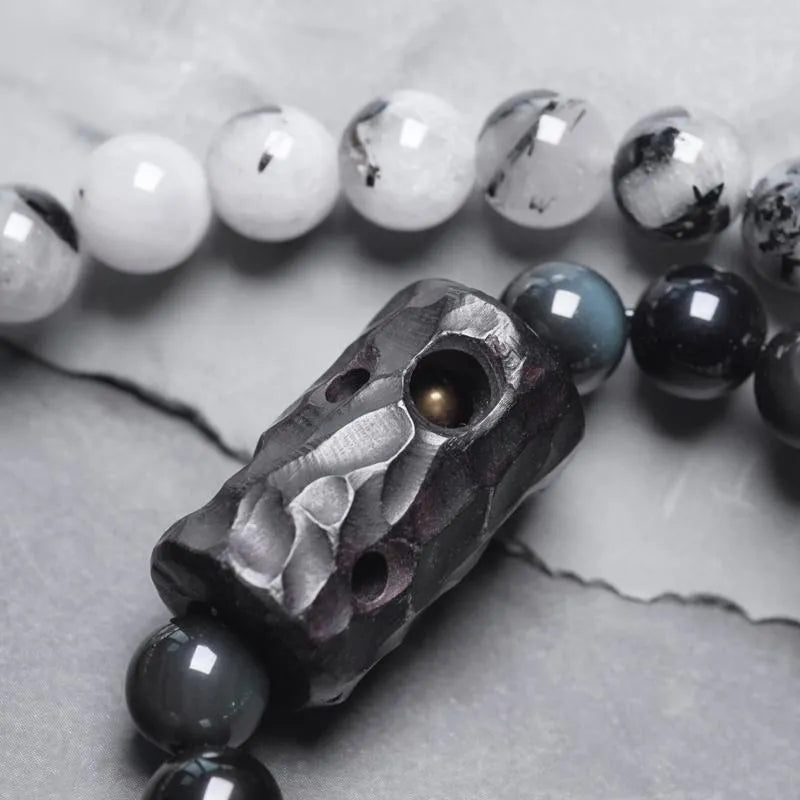 Ethnic black hair crystal bracelet with white tassel showing bending and lacing construction