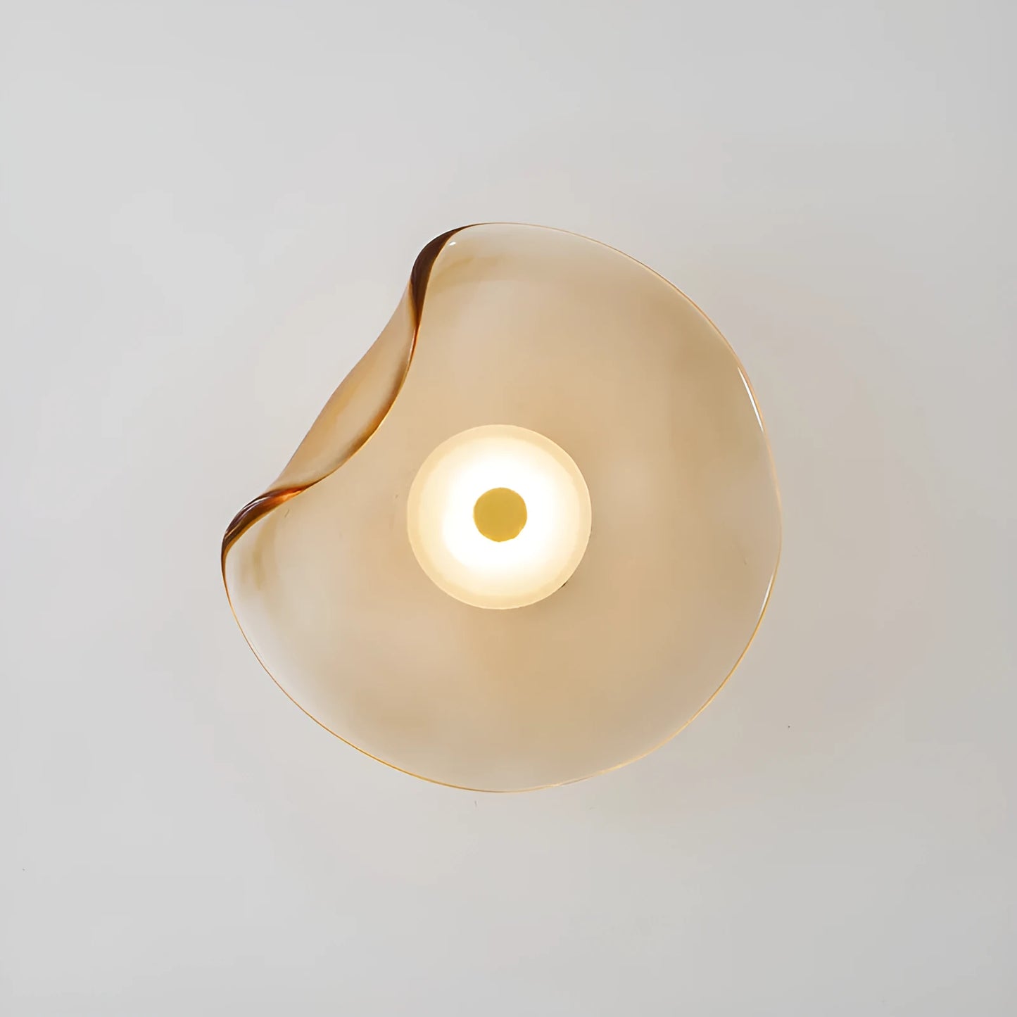 Round glass wall lamp mounted beside bed in cognac colour with 220V operation for bedside lighting