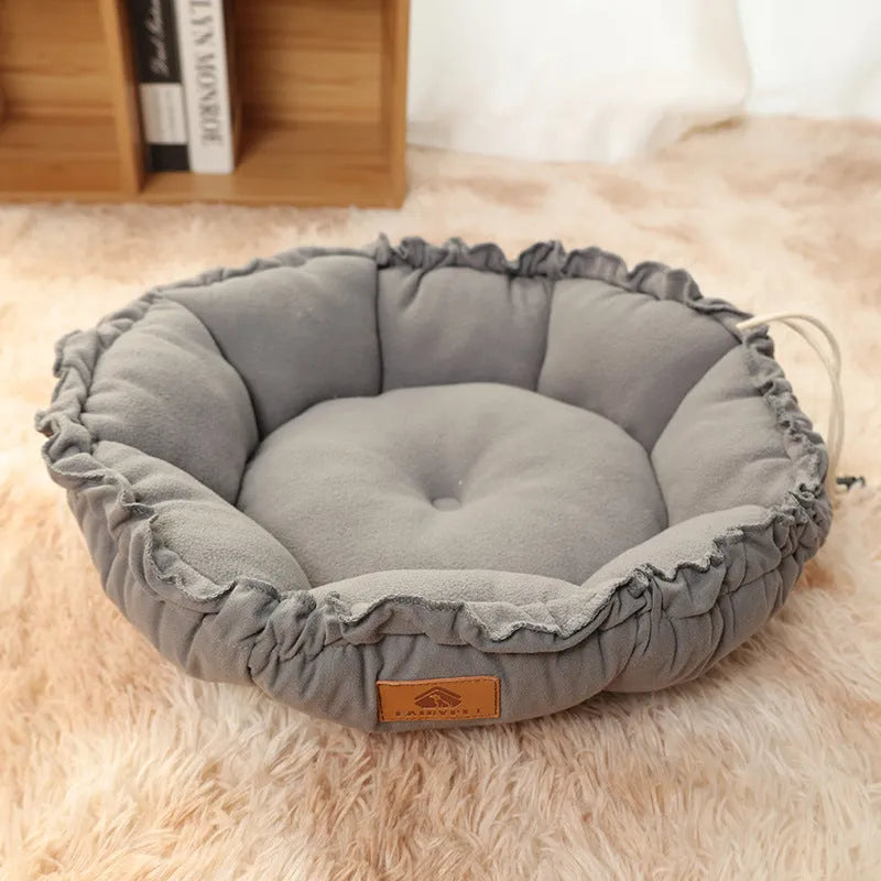 Reversible circular donut cat bed in grey and green colours showing raised outer rim