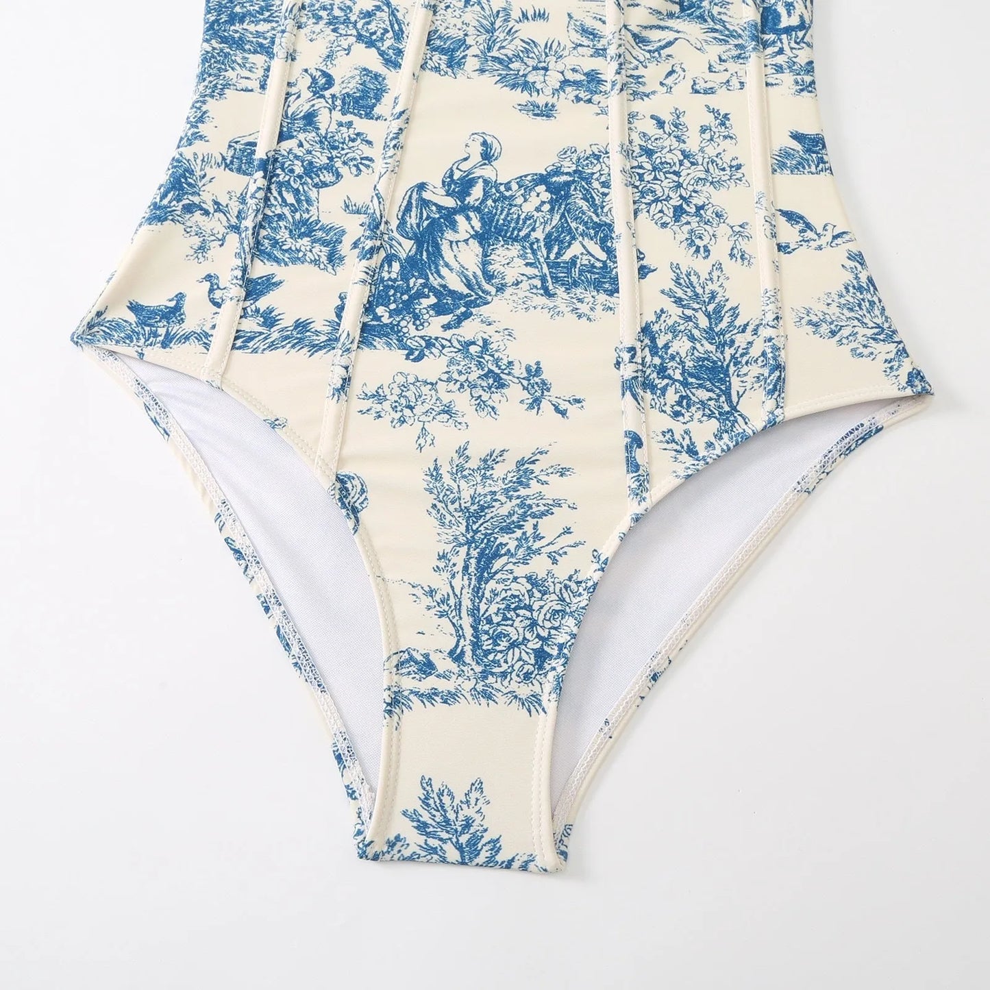 Blue women's one-piece swimsuit on a hanger with a separate gauze skirt.
