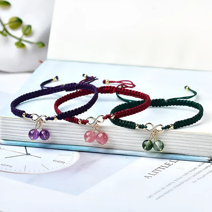 Women's adjustable bracelet with natural strawberry quartz cherry-shaped crystal charms on a chain.