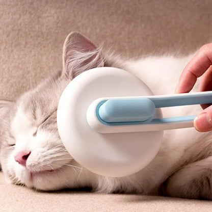 Automatic pet grooming brush with stainless steel teeth and coloured handle showing release button