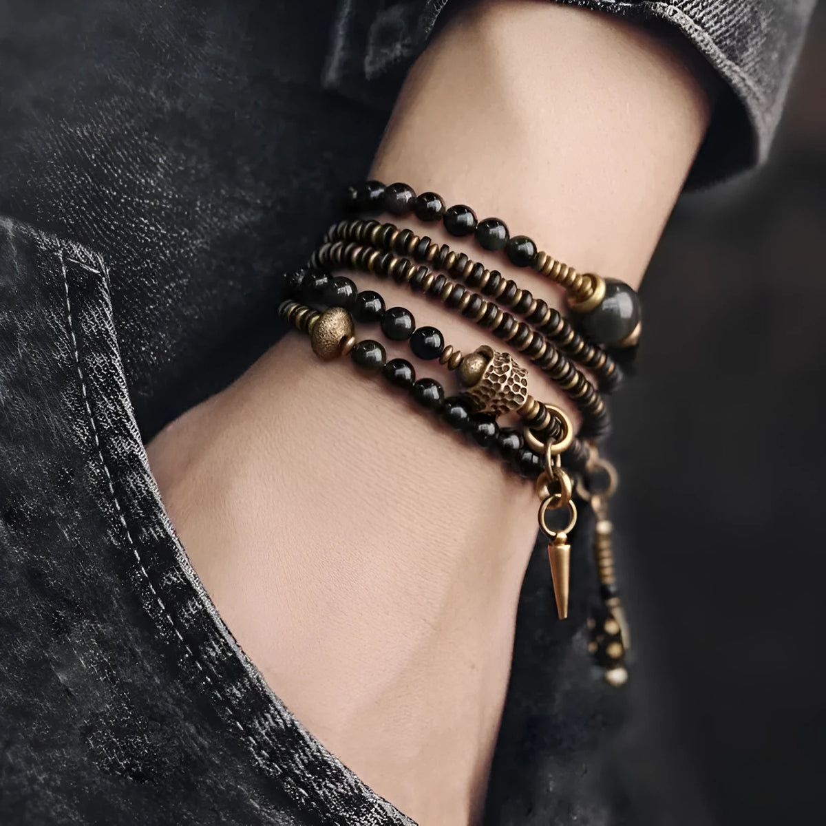 Black geometric beaded bracelet with multi-layered colourful design on wrist