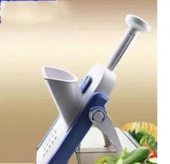 Orange multifunctional vegetable cutter kitchen tool with mandoline blades on a countertop.