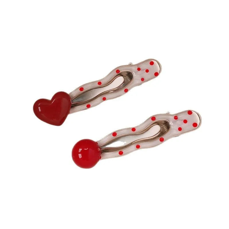 Red love heart-shaped hair barrette clip with retro white dots on a willow leaf-shaped base.
