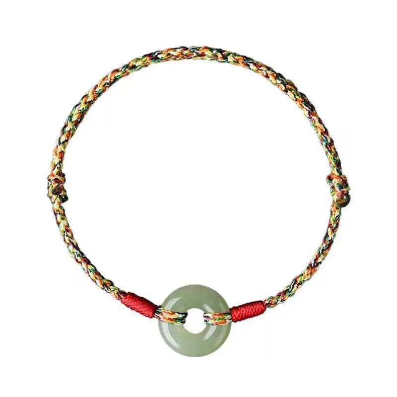 Colourful woven rope bracelet with silver peace buckle fastening on wrist