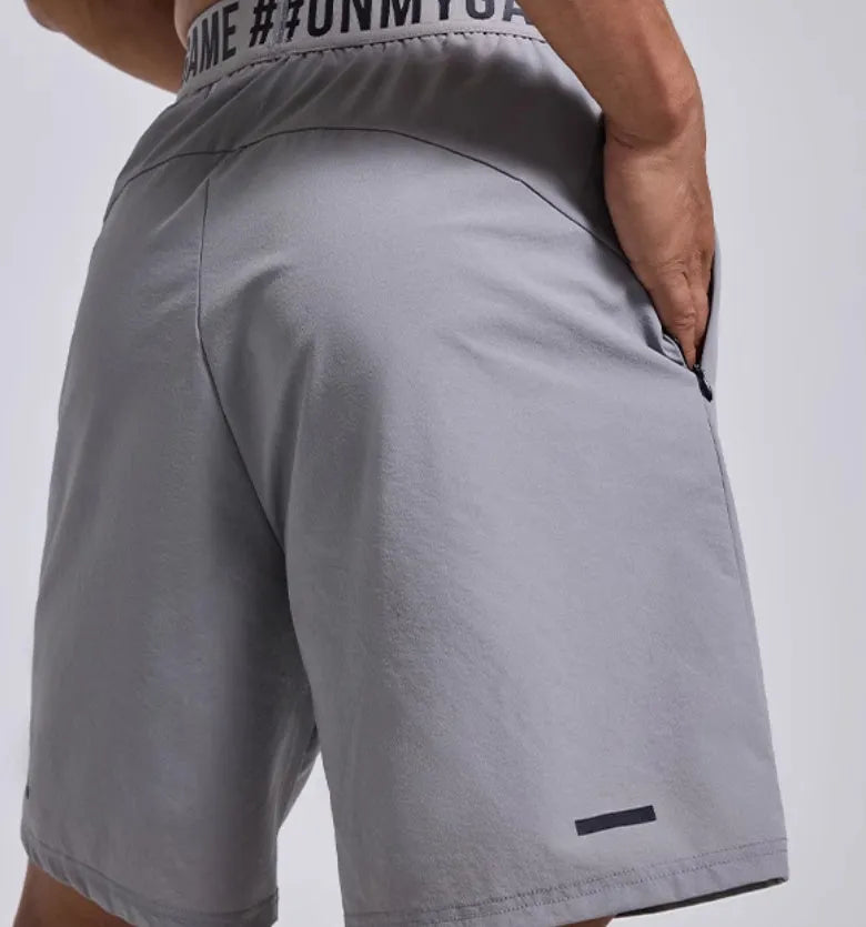 Men's loose black sports shorts with elastic waist and letter detail, shown front and back.