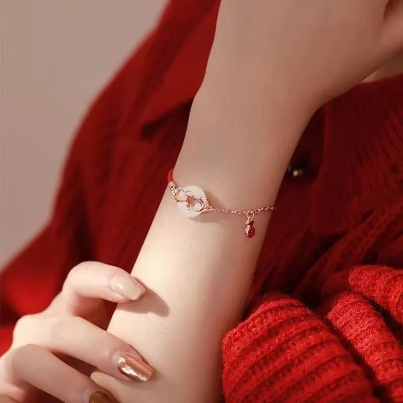 Red rope women's bracelet with electroplated peace buckle and festive koi design elements