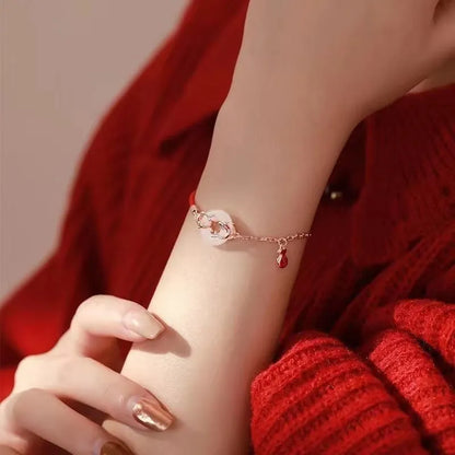 Red rope women's bracelet with electroplated peace buckle and festive koi design elements