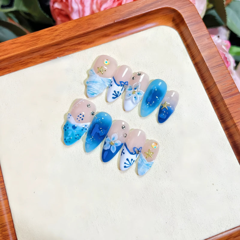 Blue hand-painted carved summer ice transparent wear fake nails: a set of plastic wearable armour for women, available in four sizes (XS, S, M, L) with a distinctive blue colour and carved design for a customised look.