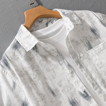 Light green men's loose-fit floral print short-sleeve cotton cardigan laid flat.