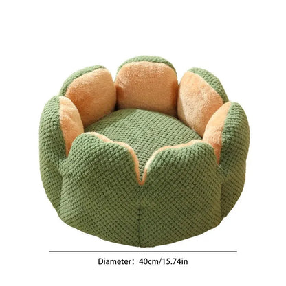 Green petal cactus-shaped plush cat bed with a cave-like opening on a wooden floor