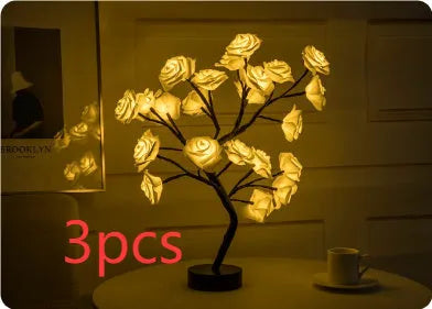 White and red rose flower LED lamp on a table with bonsai tree shape and warm white glow.