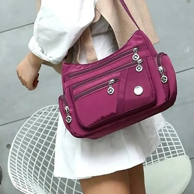 Women's nylon shoulder bag with multi-pocket design, zip opening and detachable handle in red, purple, black or army green