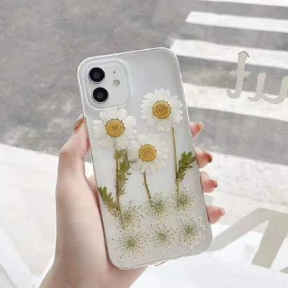 White iPhone case with a raised epoxy daisy flower pattern on the back.