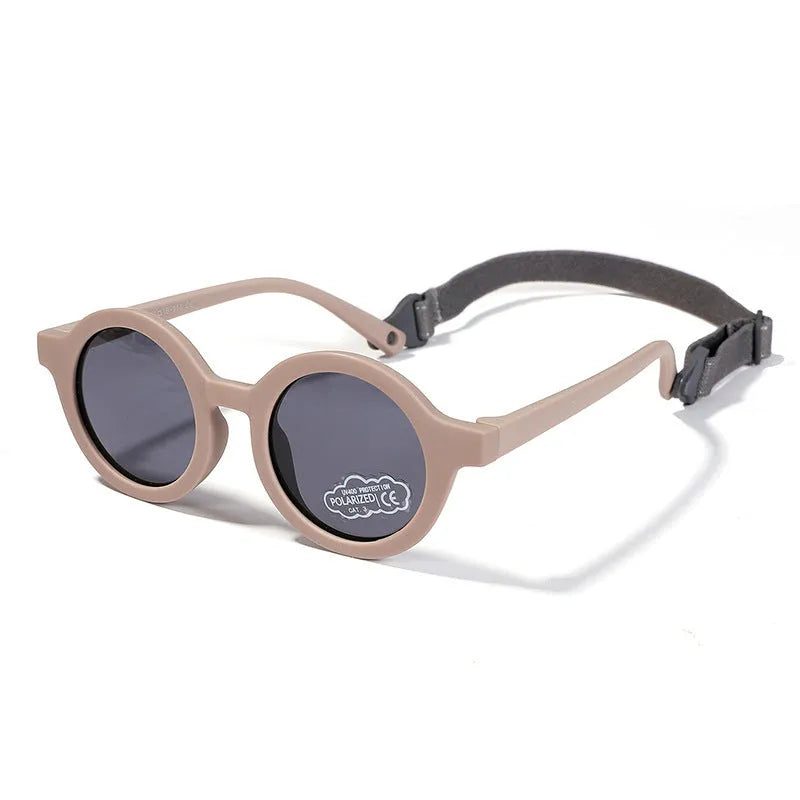 Children's round-frame polarised sunglasses with soft TPEE frame for ages 0-3, shown in assorted colours.