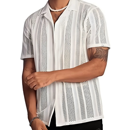 Man wearing a black short-sleeved knitted button-up shirt with a jacquard textured pattern.