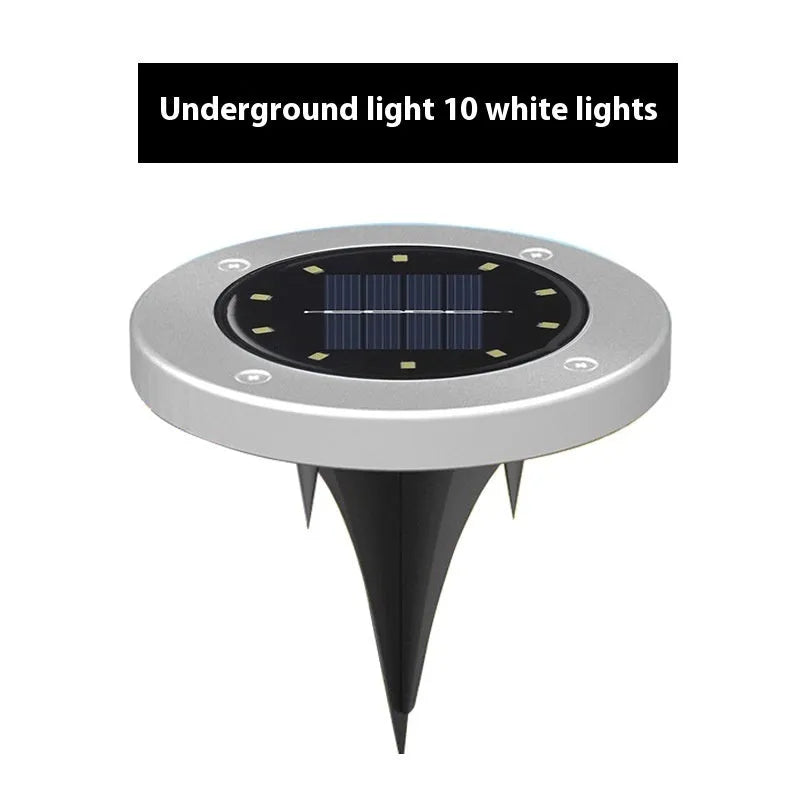 Stainless steel solar garden ground lamp installed in a lawn.