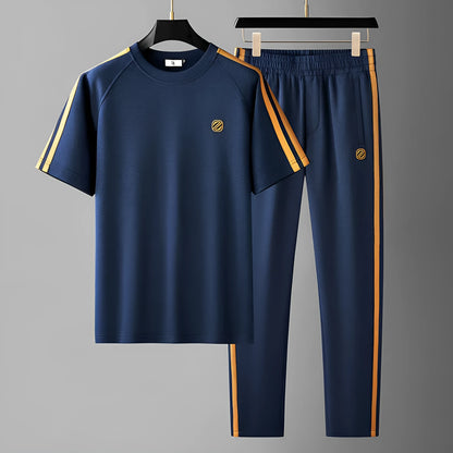 Man wearing a blue short sleeve polyester sports suit set, consisting of a top and matching pants.