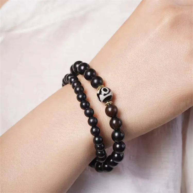 Tibet beads ebony bracelet showing two wooden circles on dark wood with 8mm diameter