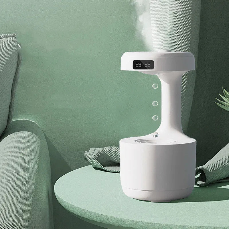 White columnar anti-gravity humidifier with water droplet backflow and LED clock display on a desk.