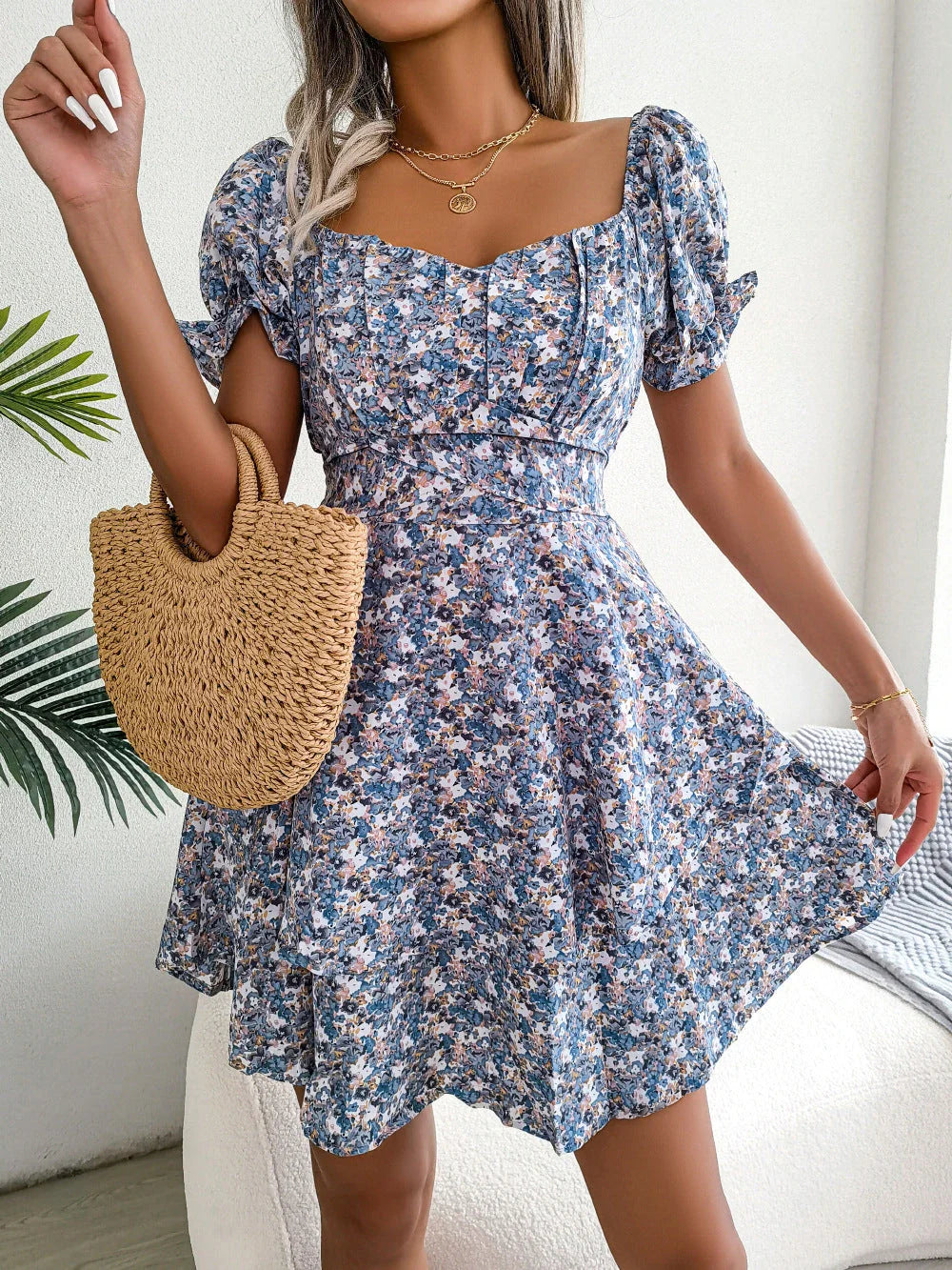 Stylish floral mini dress with ruffled skirt, high-waist design, and short sleeves for a flattering and comfortable summer look