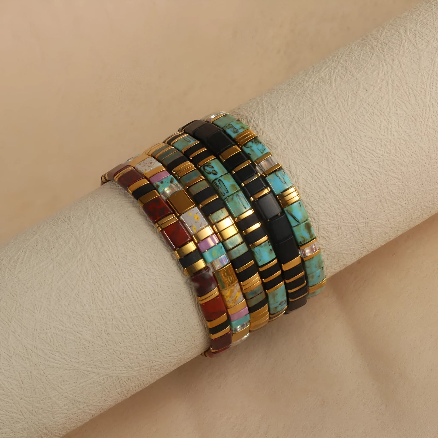 Geometric glass beaded pull bracelet in multiple colours including milky white, black, retro green, light blue, and red