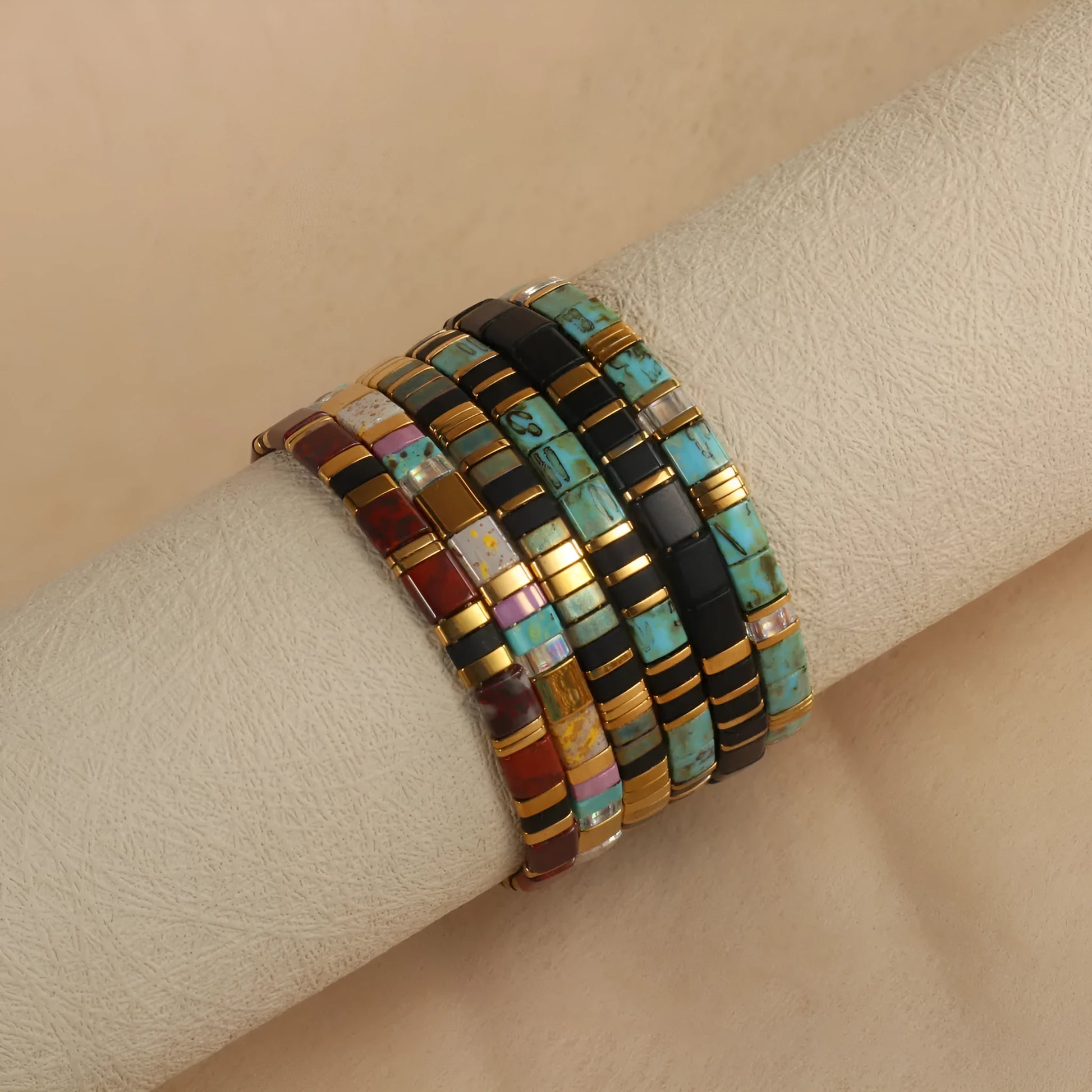 Geometric glass beaded pull bracelet in multiple colours including milky white, black, retro green, light blue, and red