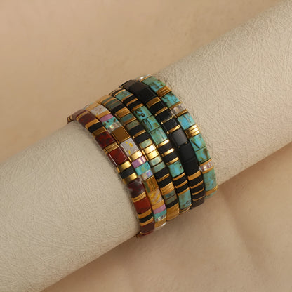 Geometric glass beaded pull bracelet in multiple colours including milky white, black, retro green, light blue, and red