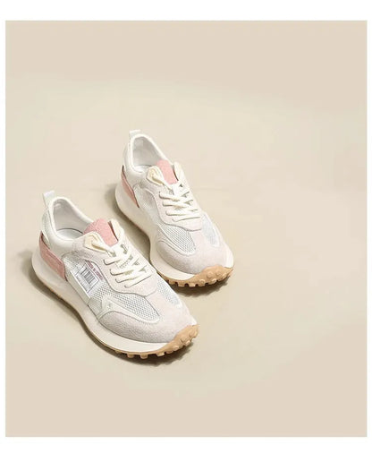 Women's grey low-top retro sneakers with mesh lining and round toe on a flat rubber sole.
