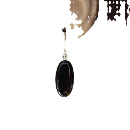A pair of women's silver-plated alloy earrings with an oval black agate geometric pendant.