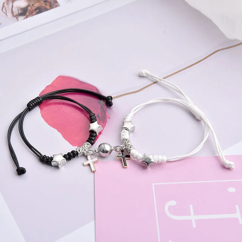 A pair of magnet couple bracelets with a suction clasp, showing various design options like clovers, crowns, and hearts.