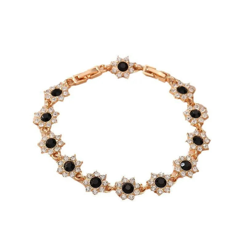 Gold and silver electroplated bracelets with flower charms set with coloured gemstones.