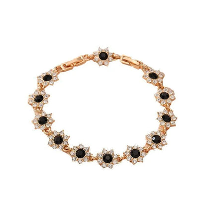 Gold and silver electroplated bracelets with flower charms set with coloured gemstones.