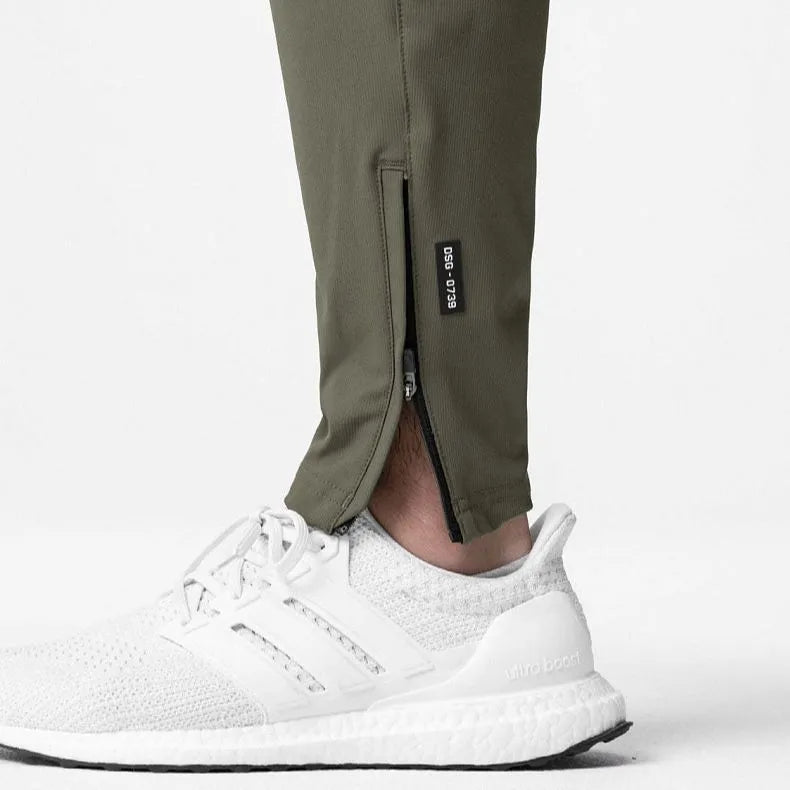 Men's grey fitness trousers with ankle ties, made from 100% polyester for quick-drying during exercise