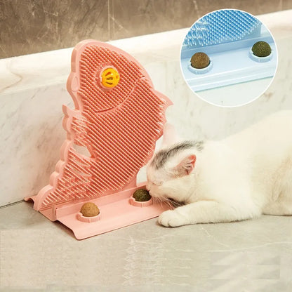 Blue plastic fish-shaped cat wall scratcher with grooming brush, catnip balls, and bell