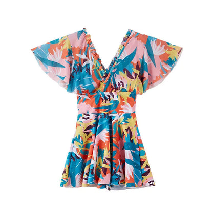 Women's colourful printed one-piece swimsuit on a mannequin, showing full coverage design.