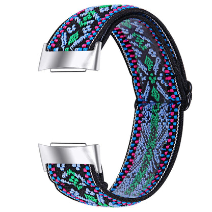 Printed elastic watch strap compatible with Fitbit Charge 6 shown in adjustable position
