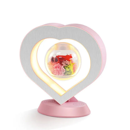 Pink rose eternal flower floating in magnetic levitation LED night light with triangular base and touch control