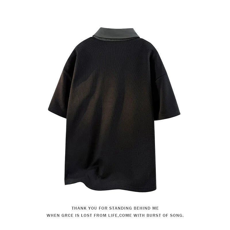 Man wearing a black henley collar short sleeve spandex pullover sweater.