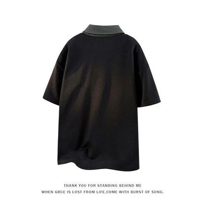 Man wearing a black henley collar short sleeve spandex pullover sweater.