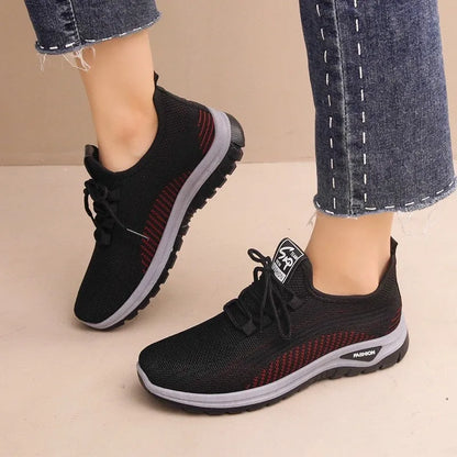 Women's black breathable mesh sneakers with round toe and cross strap lace-up detail