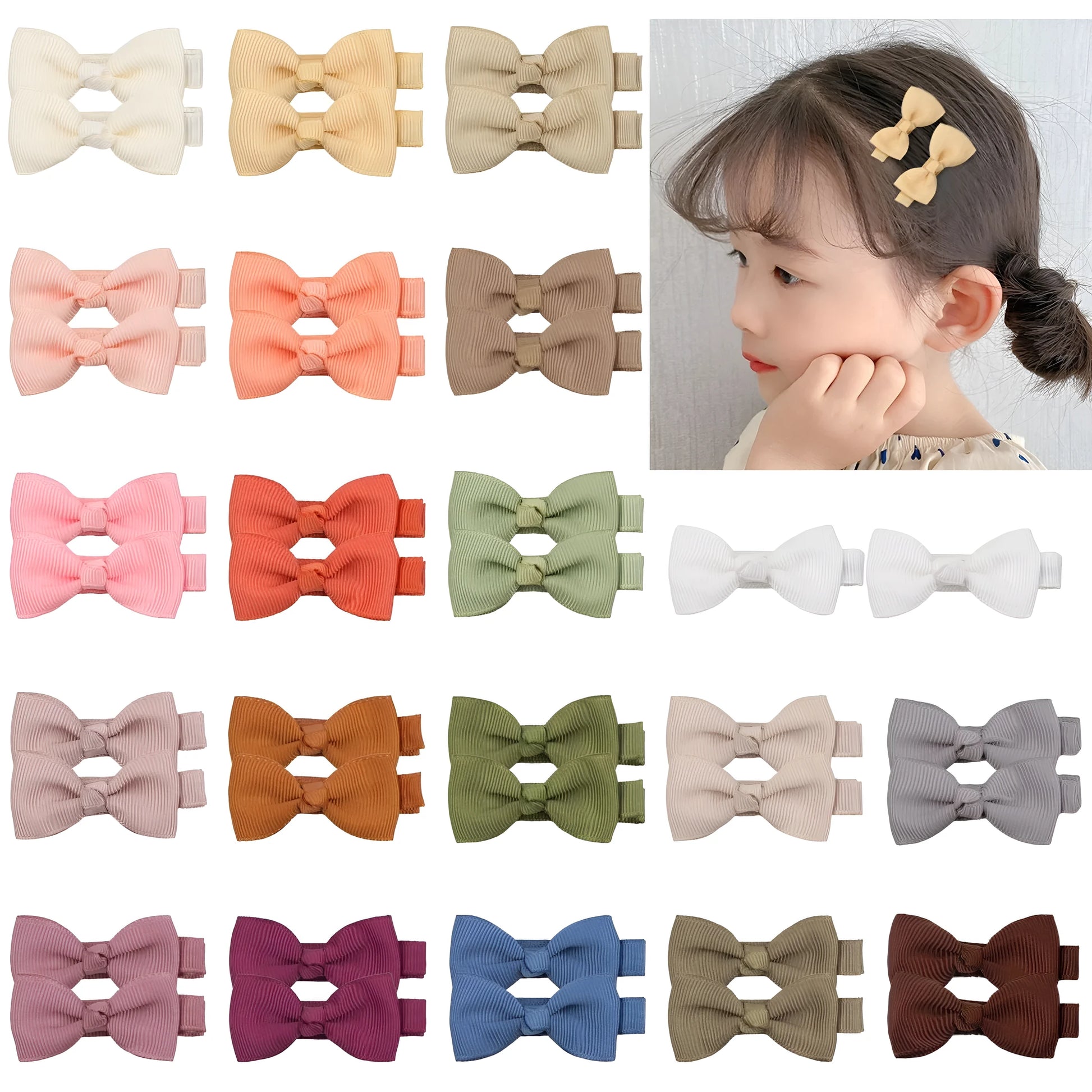 Assortment of pastel-coloured baby hair clips and bows with no-slip grips on a white background.