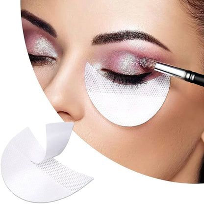 Half-moon shaped under-eye makeup shields on skin during eyeshadow application