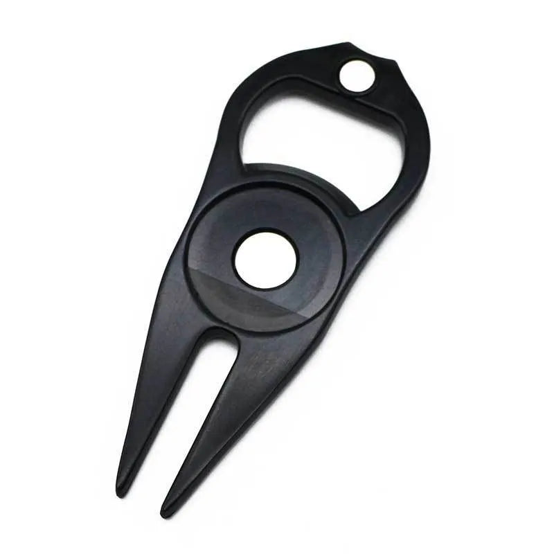 Black zinc alloy golf ball fork and bottle opener tool on a putting green.