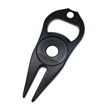 Black zinc alloy golf ball fork and bottle opener tool on a putting green.